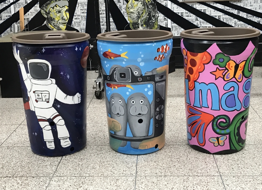 3 painted rain barrels at Oak Hills High School